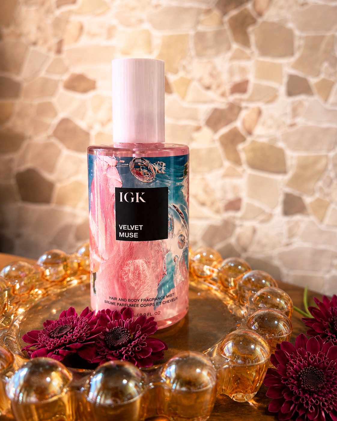 IGK Velvet Muse Hair and Body Fragrance Mist product photography with stone wall background — by Brogan Chadwell